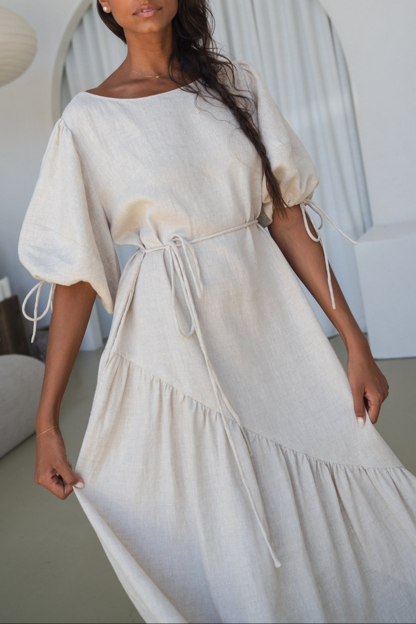 LILLY PILLY woman in an oatmeal Charlotte linen dress close up of details.