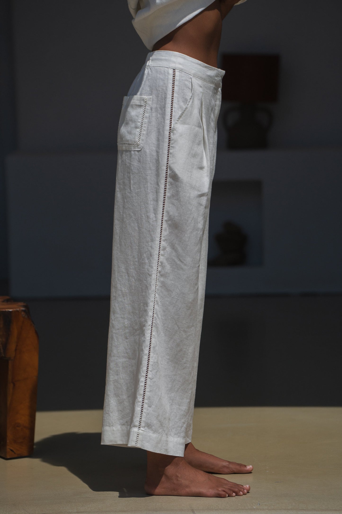 Woman in a ivory Rika linen pants side view