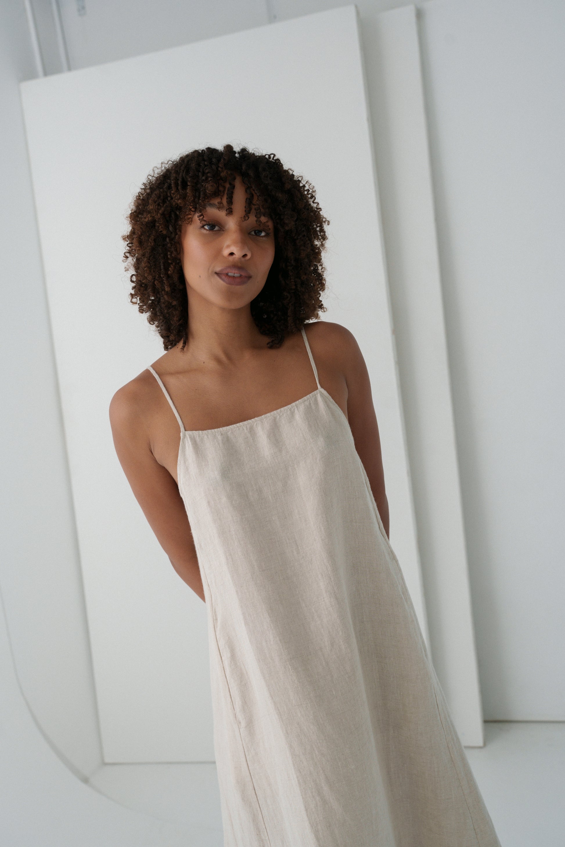 LILLY PILLY woman wearing a oatmeal Coco linen dress close up view with a white background